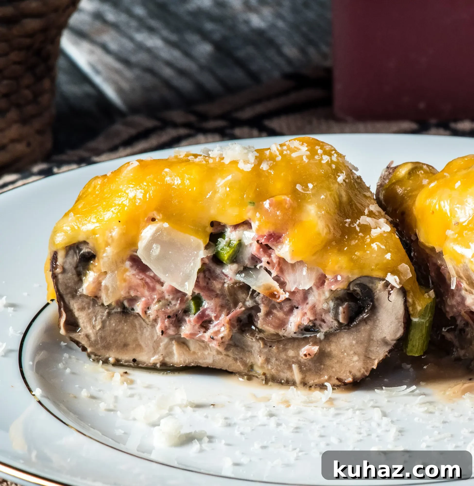 Cut stuffed portobello mushroom showing pork and cheese filling