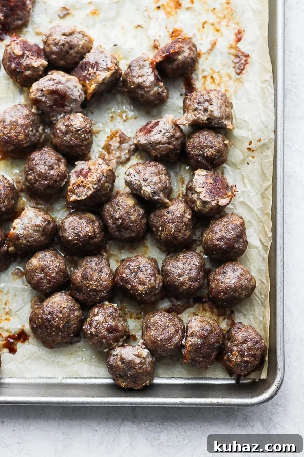 Baked Meatballs on Sheet Pan Oven baked meatballs on a baking sheet after cooking.