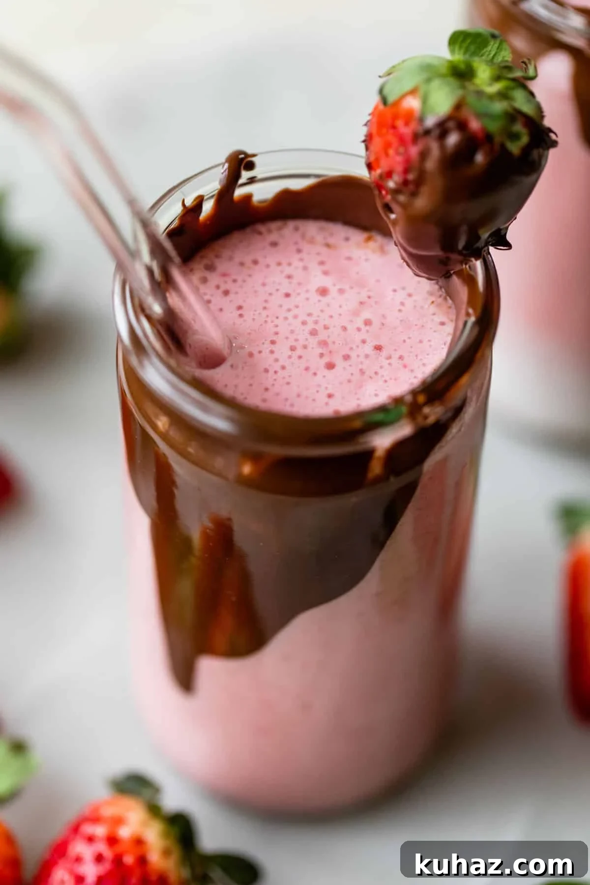 Creamy Chocolate Covered Strawberry Smoothie Recipe 2 tall glass with chocolate on the inside of it filled with a strawberry smoothie