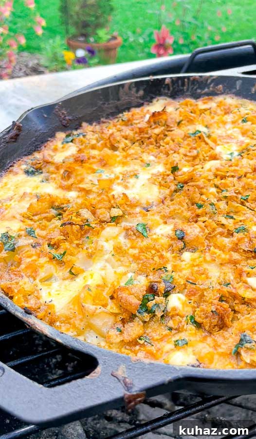 left side of a lodge cat iron skillet with easy grilled cheesy potato casserole