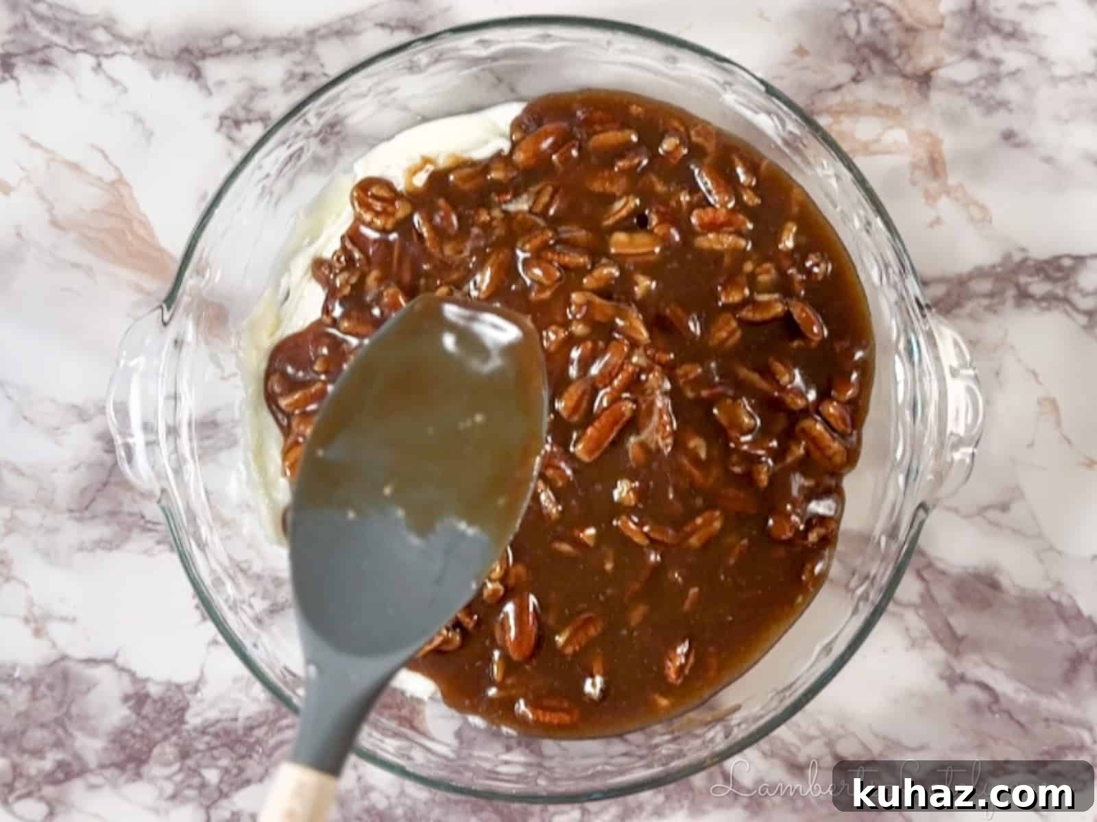 No Bake Pecan Pie Dip with Cream Cheese 6 spreading gooey pecan pie mixture over the cream cheese base in the pie dish.