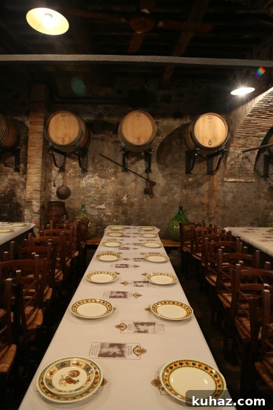 Tuscany Wine Tasting Shore Excursion from Cruise Ports 8 Cellar area with plates lining the tables and wine barrels on the wall