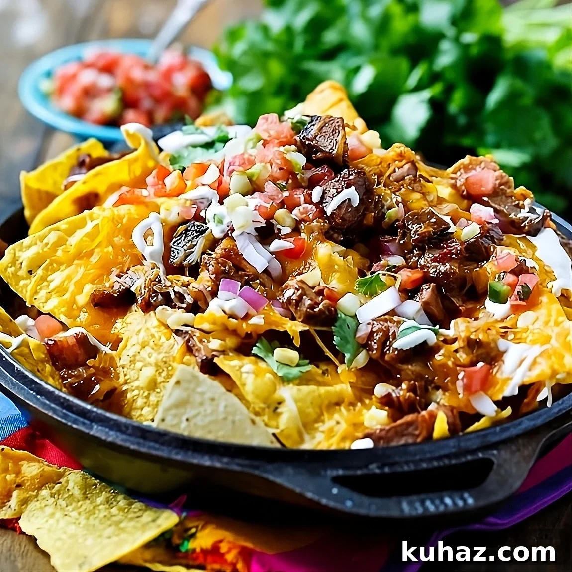 Loaded BBQ Brisket Nachos with Cheese 2 BBQ Brisket Nachos in a cast iron pan.