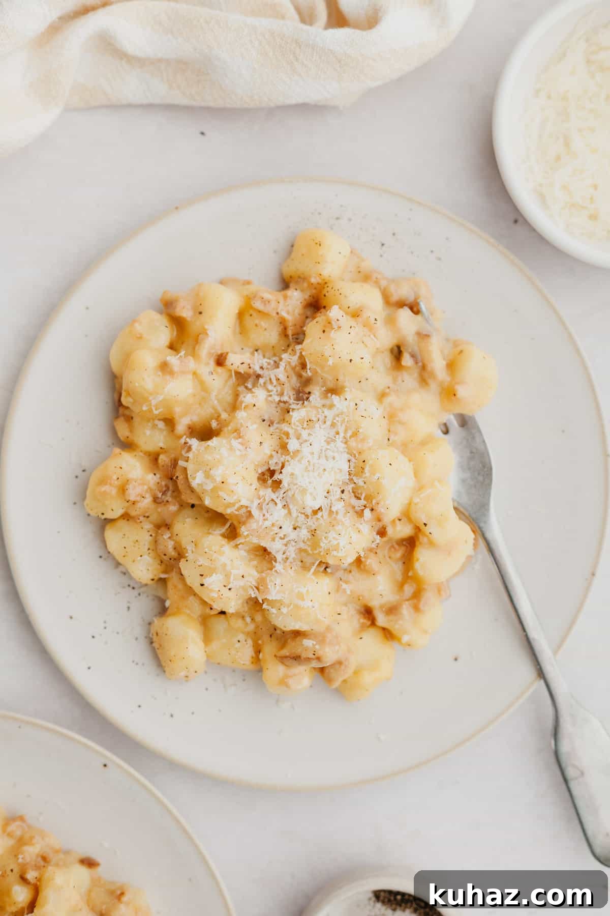 Gnocchi carbonara on a white plate.