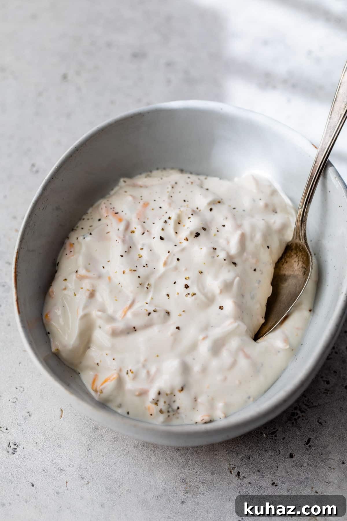 Crispy Smashed Potatoes with Sour Cream Recipe 4 sour cream, cheddar cheese, garlic powder, salt, and black pepper in a bowl with a spoon