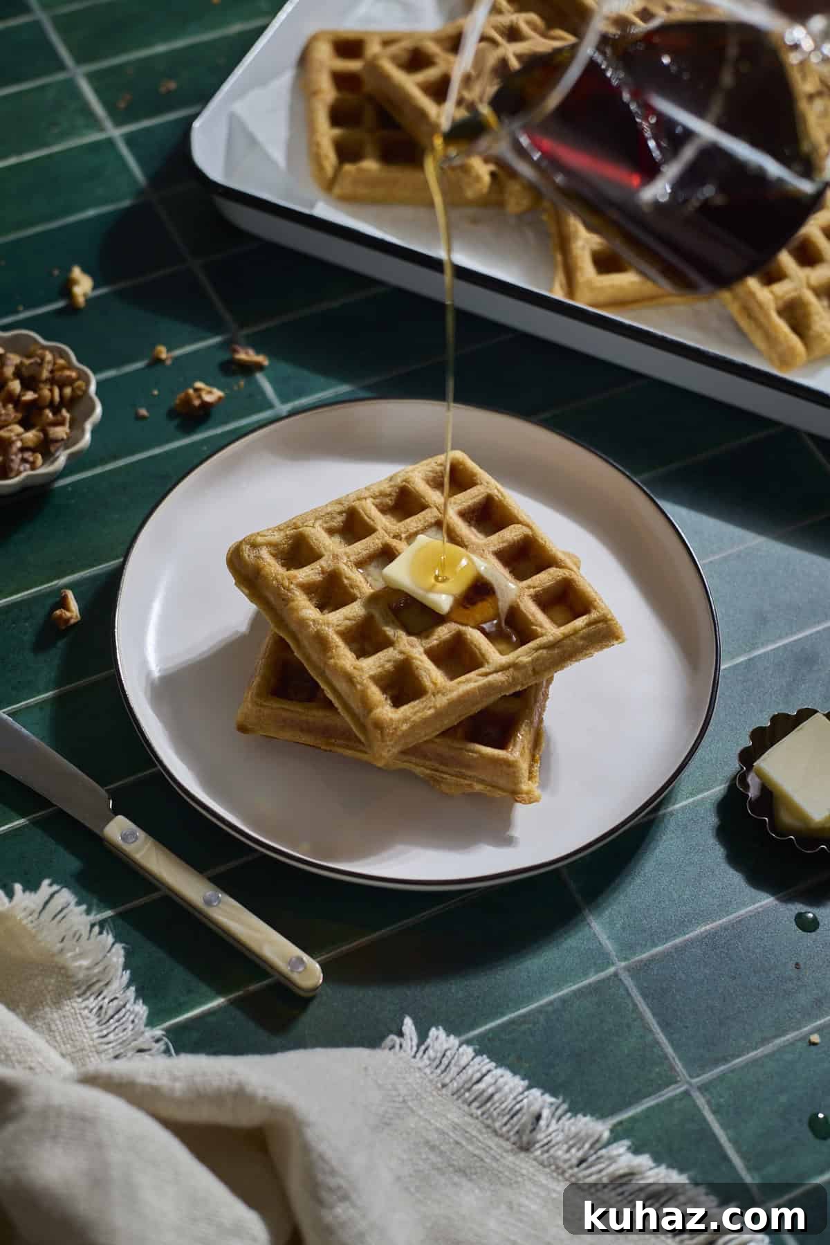 Crispy Sourdough Sweet Potato Waffles 2 Syrup pouring onto a stack of Sourdough Sweet Potato Waffles.
