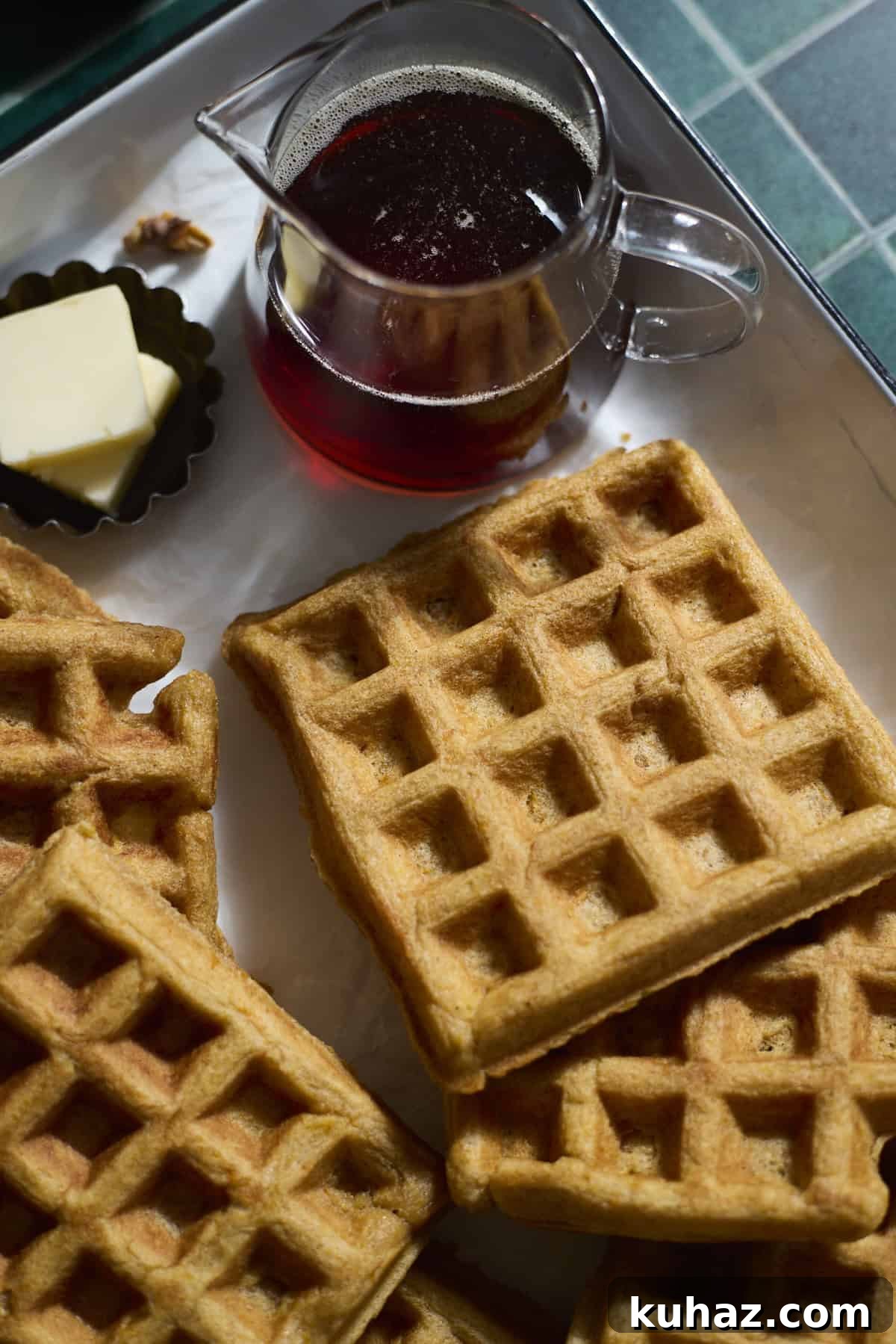 Crispy Sourdough Sweet Potato Waffles 11 A closeup of a Sourdough Sweet Potato Waffle on a white tray.
