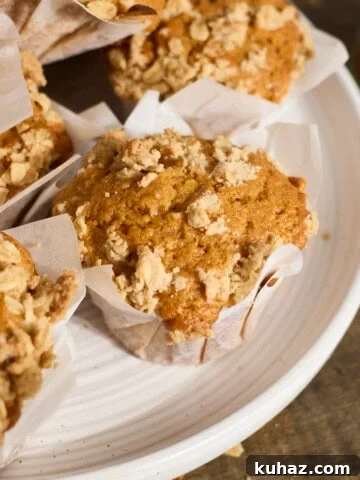 Sourdough Discard Pumpkin Muffins in a pile on a white platter.