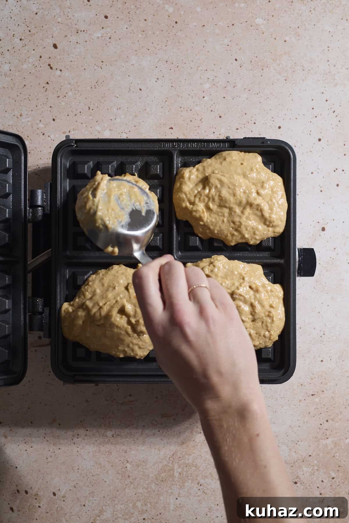 Crispy Sourdough Sweet Potato Waffles 7 Waffle batter being poured into a waffle iron.