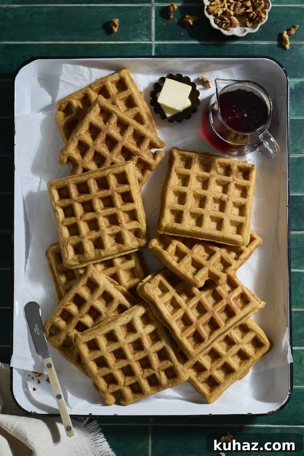 Crispy Sourdough Sweet Potato Waffles 9 A pile of Sourdough Sweet Potato Waffles on a white tray.