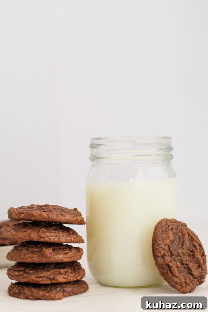 Chewy 4-Ingredient Brownie Mix Cookies 5 brownie cookies next to a glass of milk.