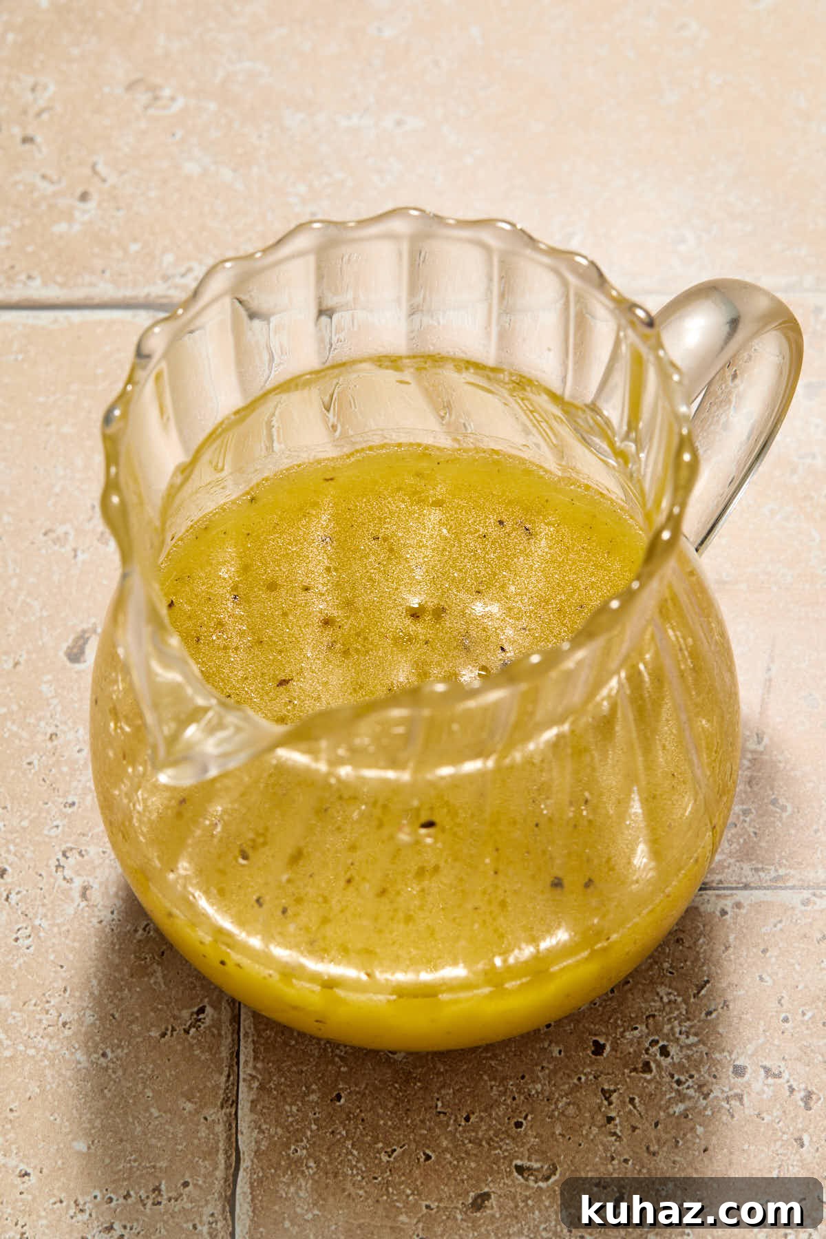 Lemon vinaigrette in a small glass jug.