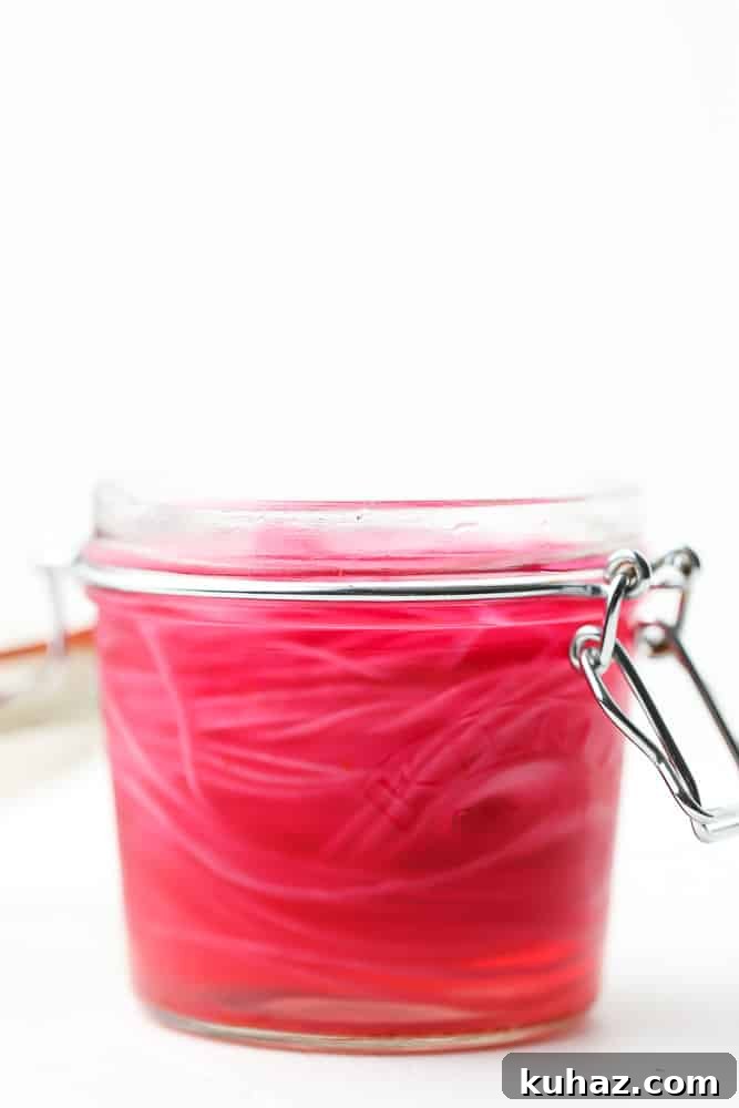 Pickled Red Onions Recipe for Tacos, Salads and Sandwiches 5 sliced red onions in a sealed mason jar