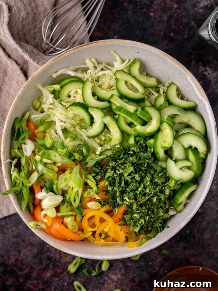cucumber, peppers, green onions, cabbage and cucumbers added to the dressing