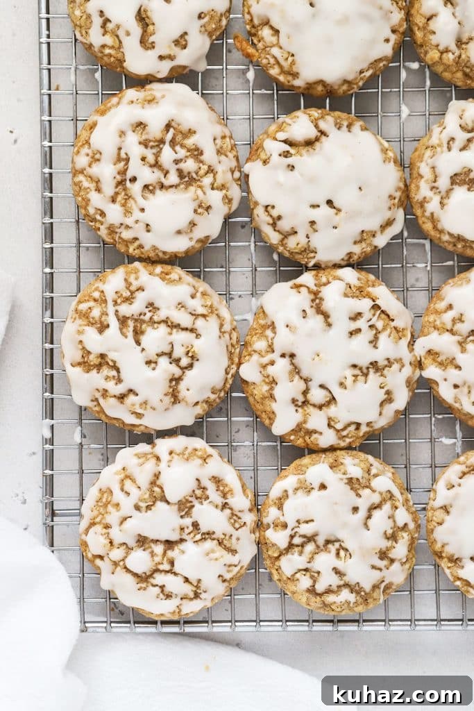 Gluten Free Cranberry White Chocolate Oatmeal Cookies 11 gluten-free iced oatmeal cookies on a cooling rack