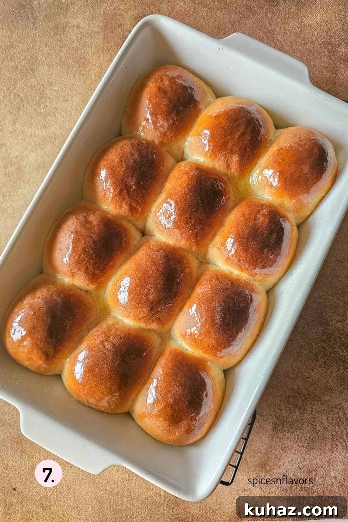 Fluffy Homemade Bread Machine Dinner Rolls Recipe 8 applying butter on baked dinner rolls