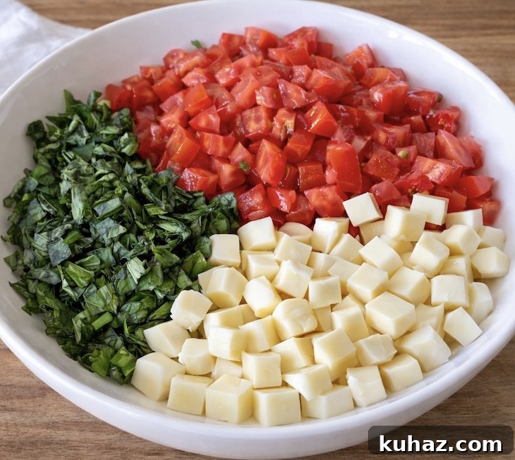 Chopped Caprese Toast with Balsamic Glaze 4 Step 1 How To make Caprese Toast: Chopped mozzarella, tomatoes, and fresh basil in a bowl.