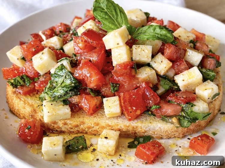 Chopped Caprese Toast with Balsamic Glaze 7 Close up view of delicious caprese toast a vegetarian lunch or dinner made with fresh tomatoes, basil, and mozzarella cheese.