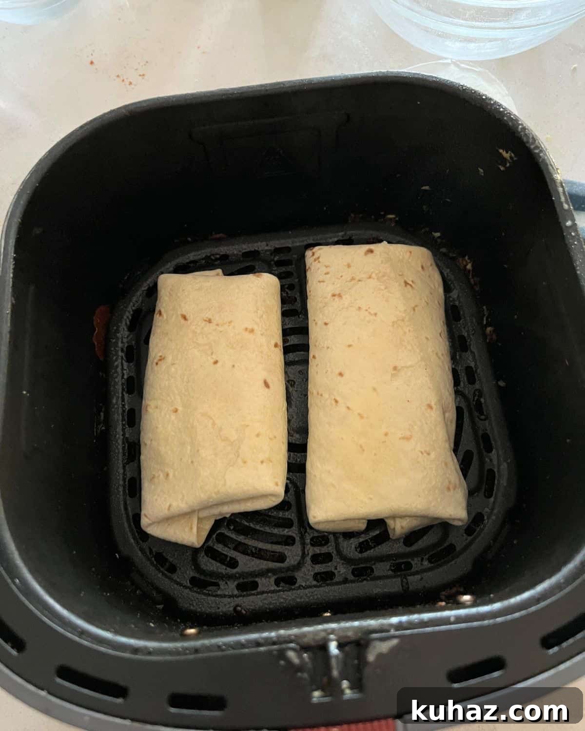 Crispy Air Fryer Chicken Chimichangas 6 Chimichangas in air fryer basket.