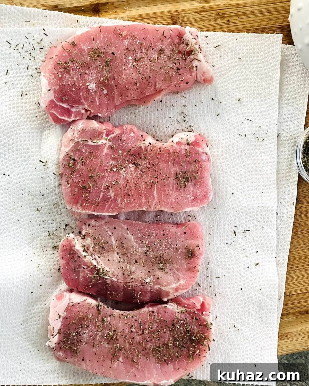 Seasoning pork chops.