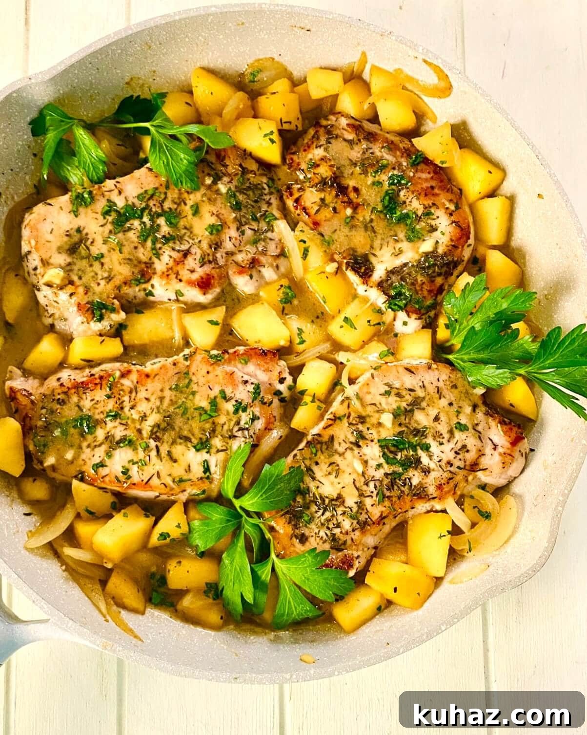 Adding pork chops with apples and onions.