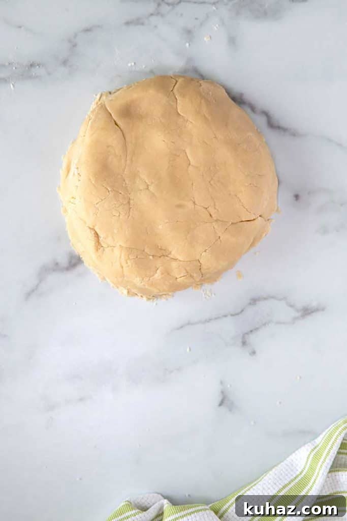 Easter Bunny Cookies with Fluffy Marshmallow Tails 11 shortbread cookie dough shaped into a ball on a marble surface