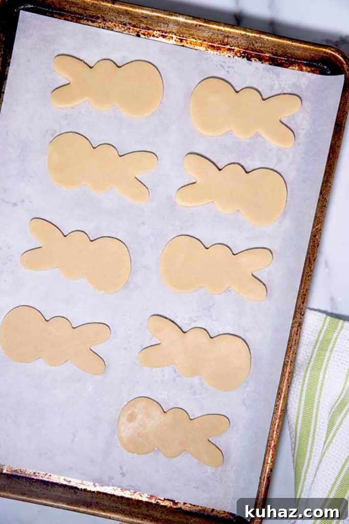 Easter Bunny Cookies with Fluffy Marshmallow Tails 13 bunny cookie dough lined up on a baking tray