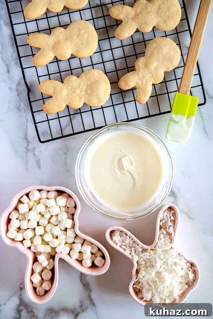 Easter Bunny Cookies with Fluffy Marshmallow Tails 14 top view of melted white chocolate next to the bunny cookies, marshmallows and shredded coconut