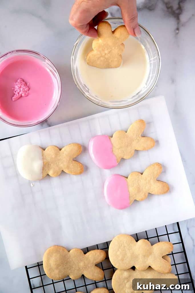 Easter Bunny Cookies with Fluffy Marshmallow Tails 15 dipping the bunny cookies into melted white chocolate