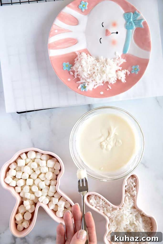 Easter Bunny Cookies with Fluffy Marshmallow Tails 16 dipping a little marshmallow into melted white chocolate