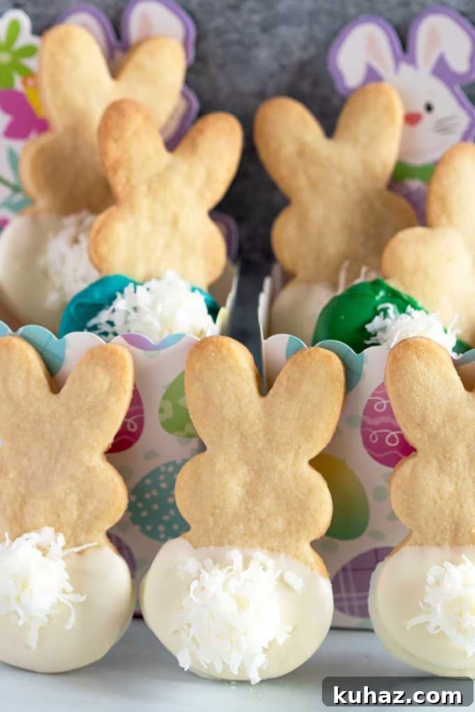 Easter Bunny Cookies with Fluffy Marshmallow Tails 19 Festive Bunny cookies dipped in white chocolate with marshmallow tails