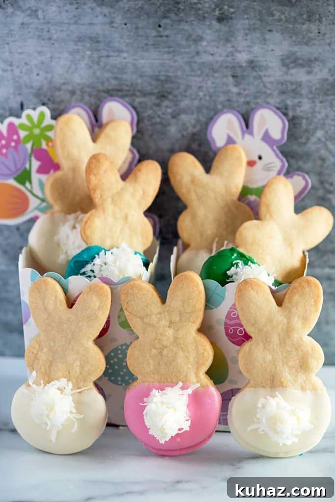 Easter Bunny Cookies with Fluffy Marshmallow Tails 3 Cute and festive Easter Bunny Cookies made with shortbread cookies dipped in chocolate.