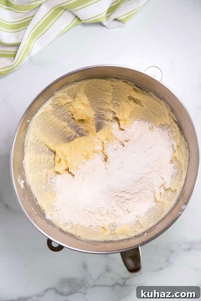 Easter Bunny Cookies with Fluffy Marshmallow Tails 8 adding flour into the butter and sugar mixture