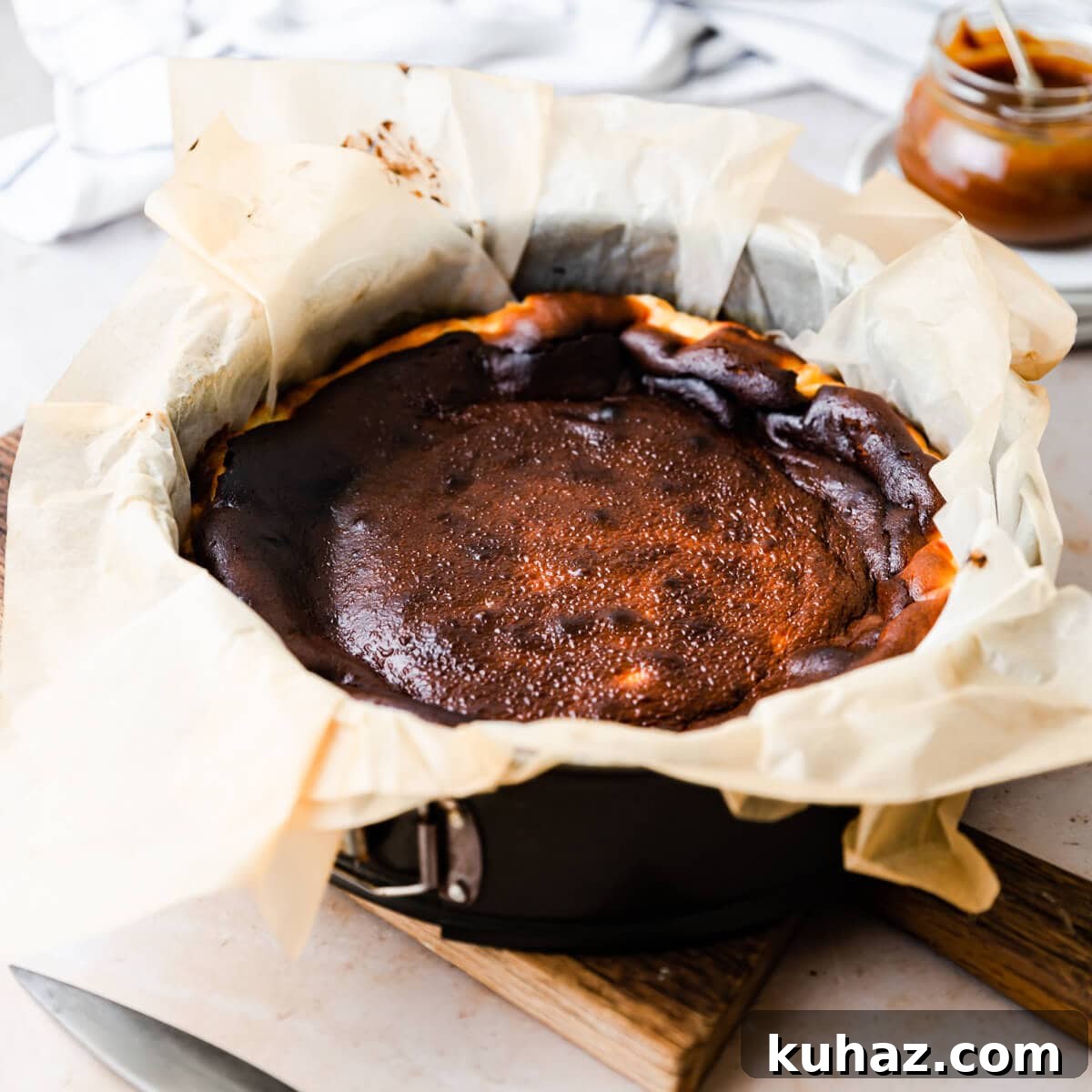 Basque Burnt Cheesecake Recipe — Silky, Caramelized Top 7 burnt cheesecake inside of the baking tin lined with plenty of baking paper.