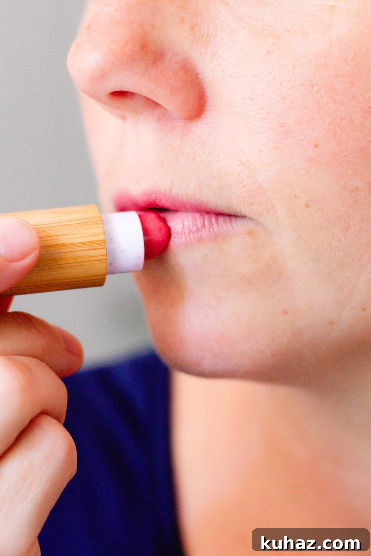 Applying homemade lipstick to the lips.