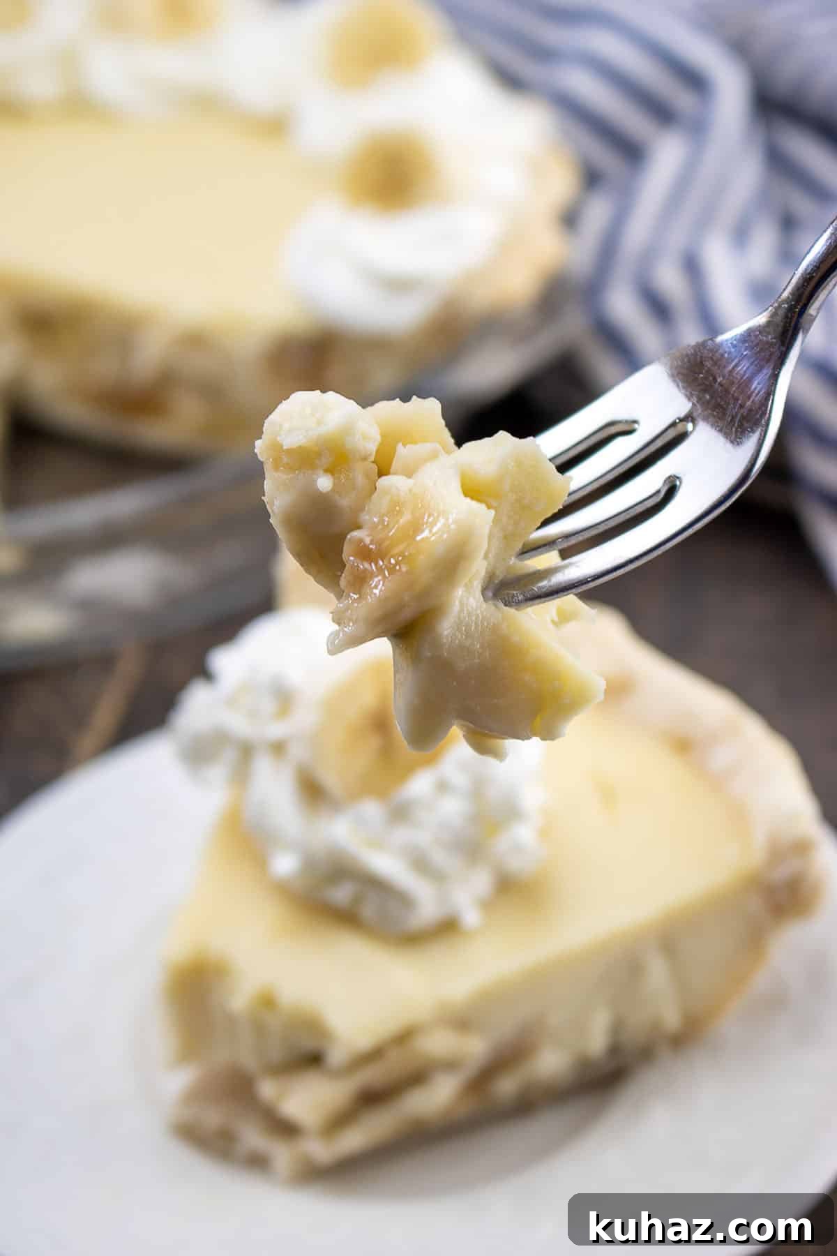 Gluten-Free Banana Cream Pie Recipe 3 piece of pie on fork with whipped cream and banana slice on top