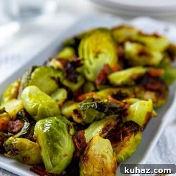 cooked brussels sprouts and bacon in white rectangular dish
