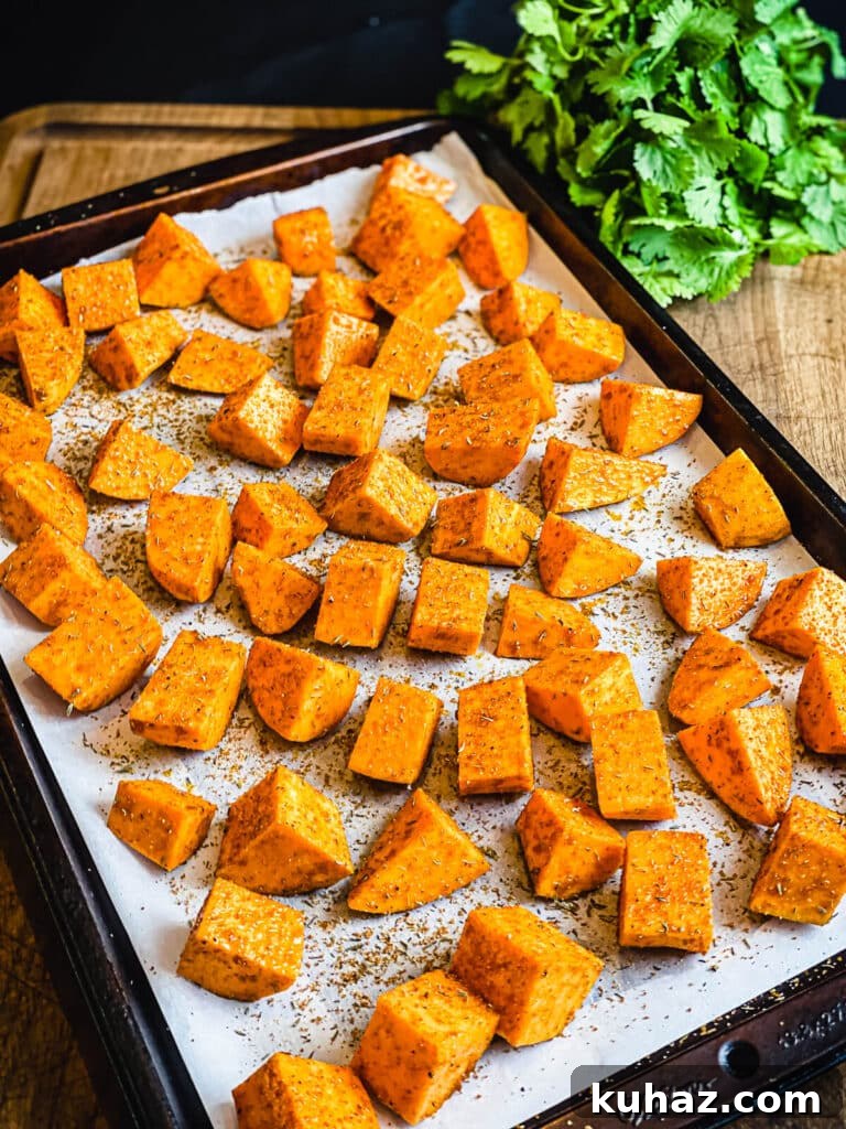 How to Grill or Roast Sweet Potatoes 9 seasoned sweet potatoes on a parchment lined baking sheet