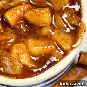 Top down view of a dish of pear pie filling in brown sugar sauce.