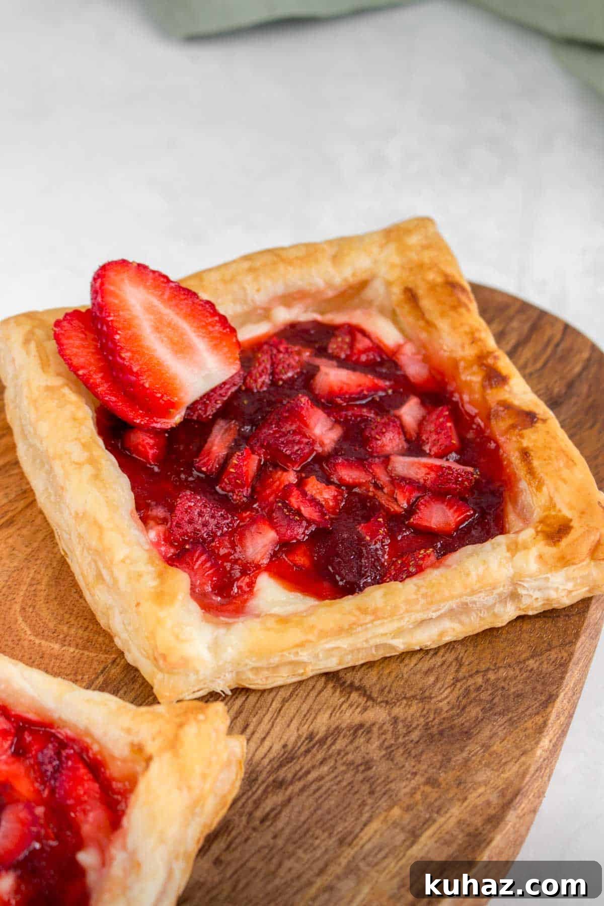 Flaky Homemade Strawberry Danish with Cream Cheese Recipe 10 A strawberry danish with a slice of strawberry on top.