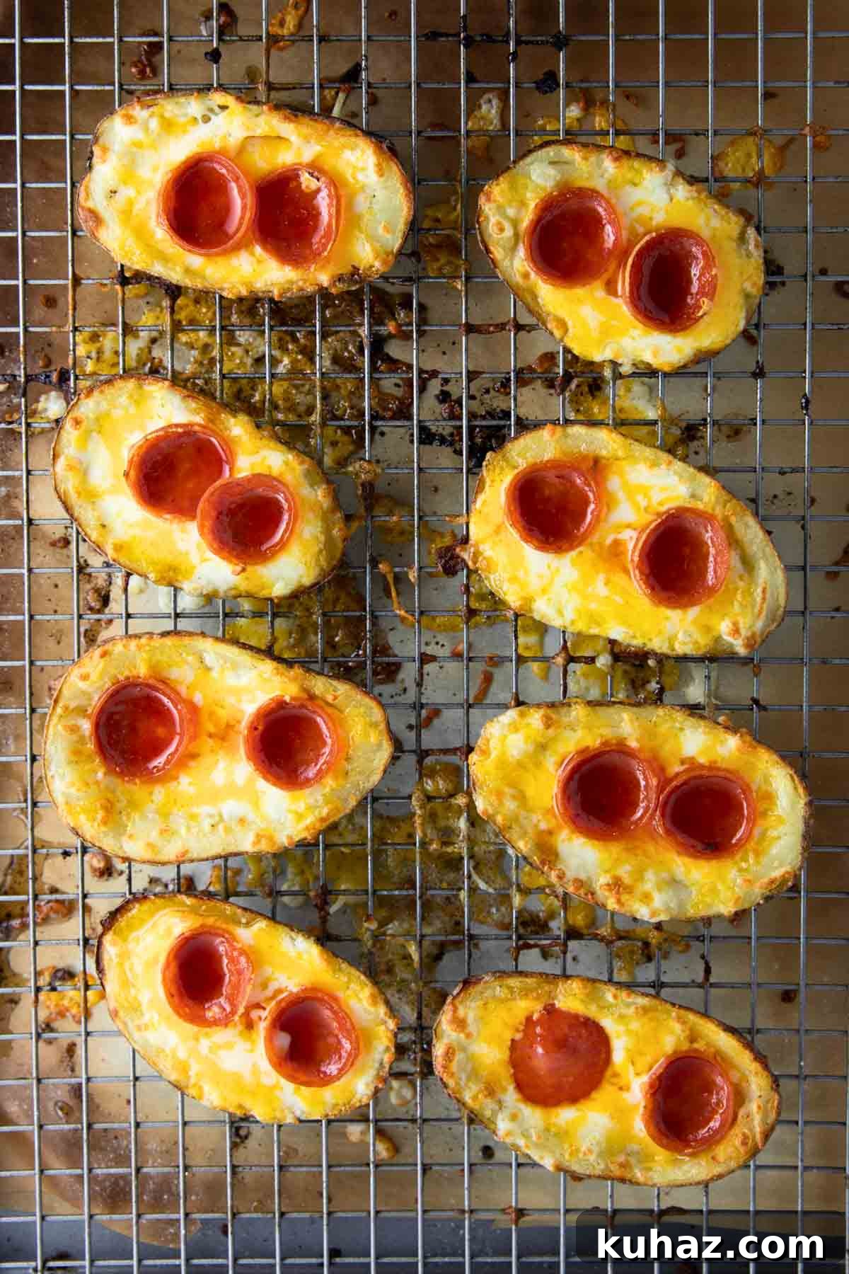 Pizza-Style Potato Skins Recipe with Pepperoni & Mozzarella 11 a baking tray with pizza potato skins sizzling in the oven