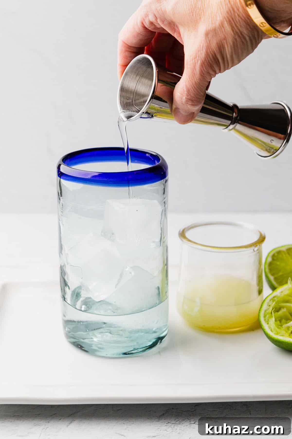 Pouring tequila into glass.
