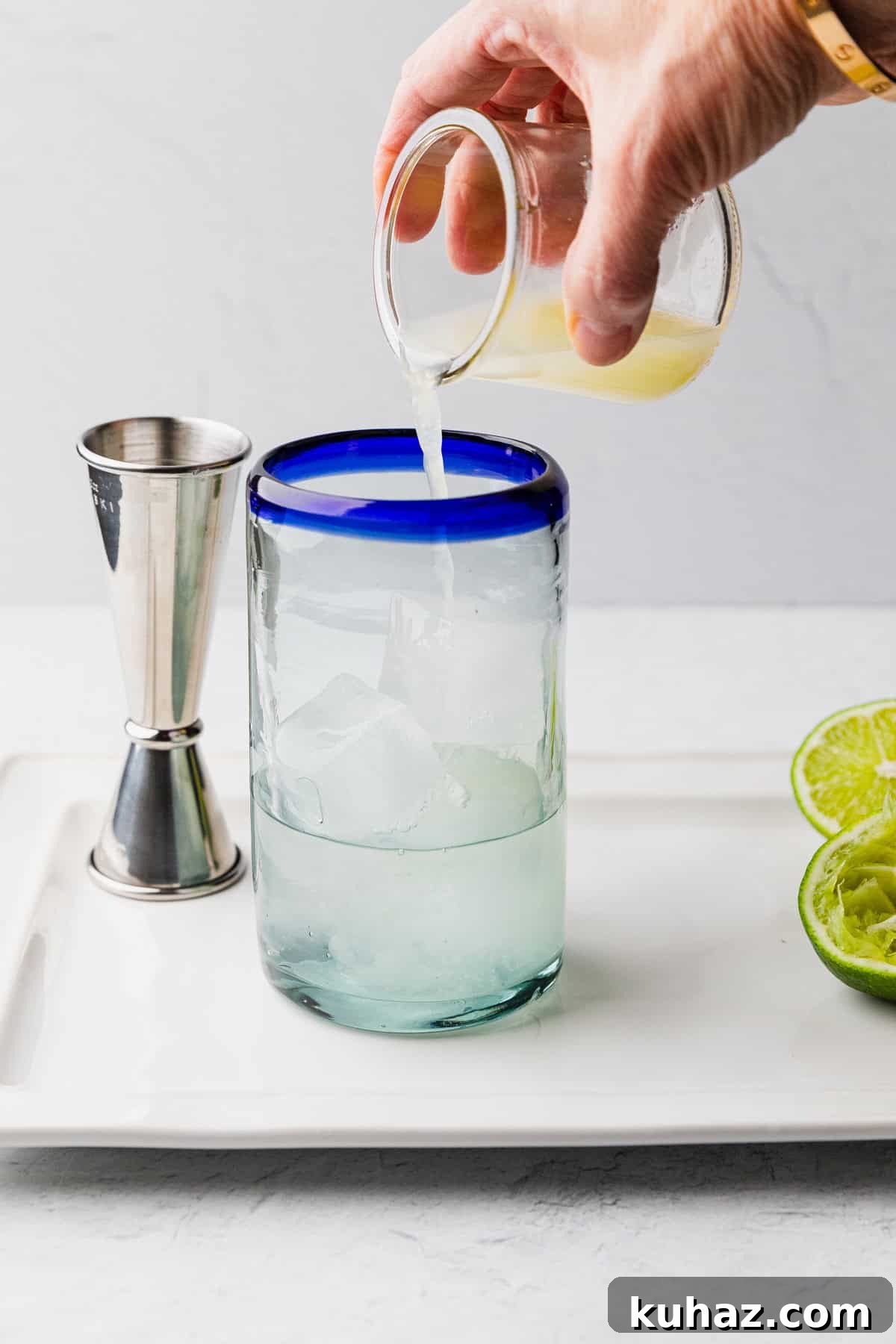 Pour lime into glass.