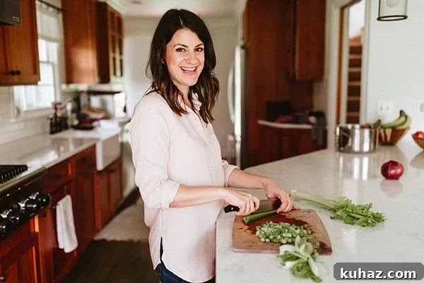Image of a woman smiling and prepping ingredients