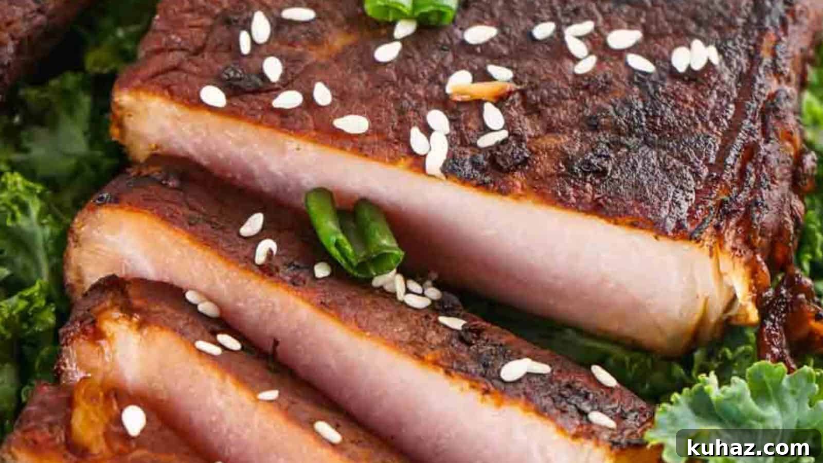 19 Asian Recipes That Fed My Family for $20 9 Close-up of sliced grilled pork belly garnished with sesame seeds and green chili, served on a bed of kale.