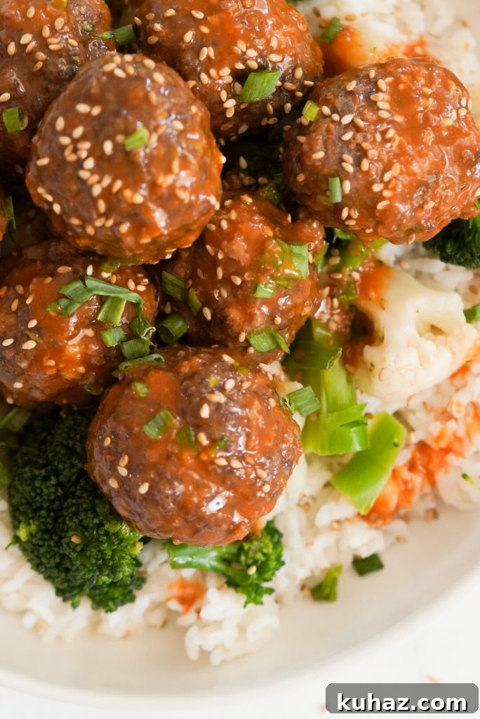 Spicy Firecracker Meatballs Recipe with Sweet Chili Glaze 14 overhead shot of beef firecracker meatballs in a white bowl with white rice and steamed broccoli.