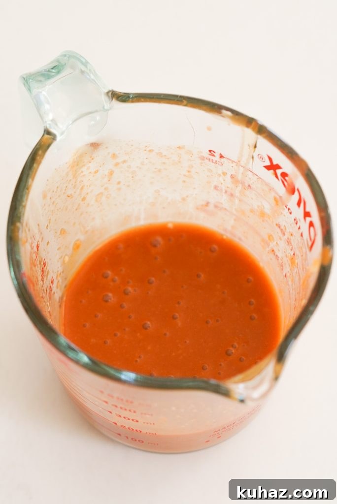 Spicy Firecracker Meatballs Recipe with Sweet Chili Glaze 10 homemade firecracker sauce in a 2-cup measuring cup.