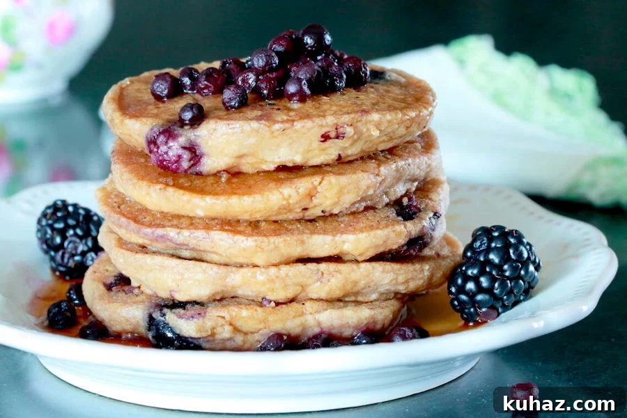 Fluffy Gluten Free Vegan Blueberry Oatmeal Pancakes 2 Stack of fluffy blueberry oatmeal pancakes with fresh wild blueberries, blackberries, and maple syrup