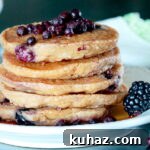Fluffy Gluten Free Vegan Blueberry Oatmeal Pancakes 7 Stack of fluffy blueberry oatmeal pancakes with fresh wild blueberries, blackberries, and maple syrup