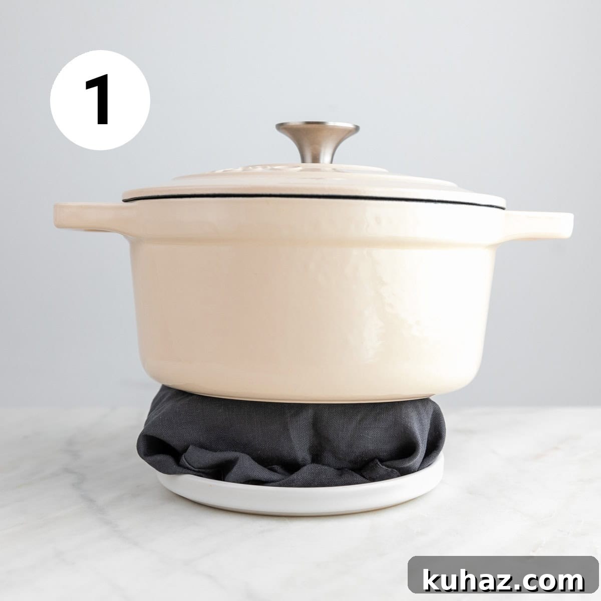 Homemade Vegan Feta Cheese Recipe 4 Tofu wrapped in a clean towel on a plate with a pot on top.